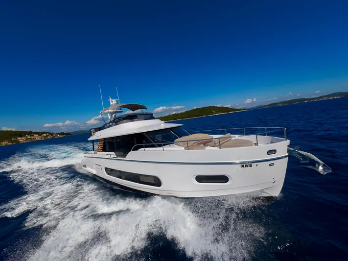 Olivia Yacht Photos Pics Azimut Magellano 60 yacht cruising on open sea, 2025 model, under clear blue sky.