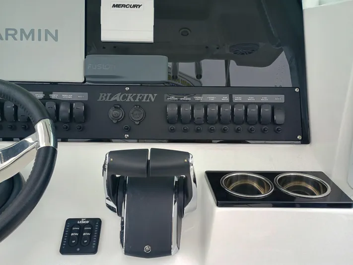  Yacht Photos Pics 2025 Blackfin 252 CC boat dashboard with controls, steering wheel, and cup holders.