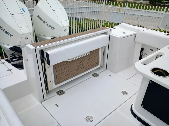 Yacht Photos Pics 2025 Blackfin 252 CC boat deck with Mercury engines and seating area.