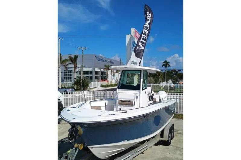  Yacht Photos Pics 2025 Blackfin 252 CC boat displayed at dealership with clear blue sky.
