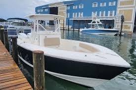 2017 Stamas 308 Predator boat docked near blue building.