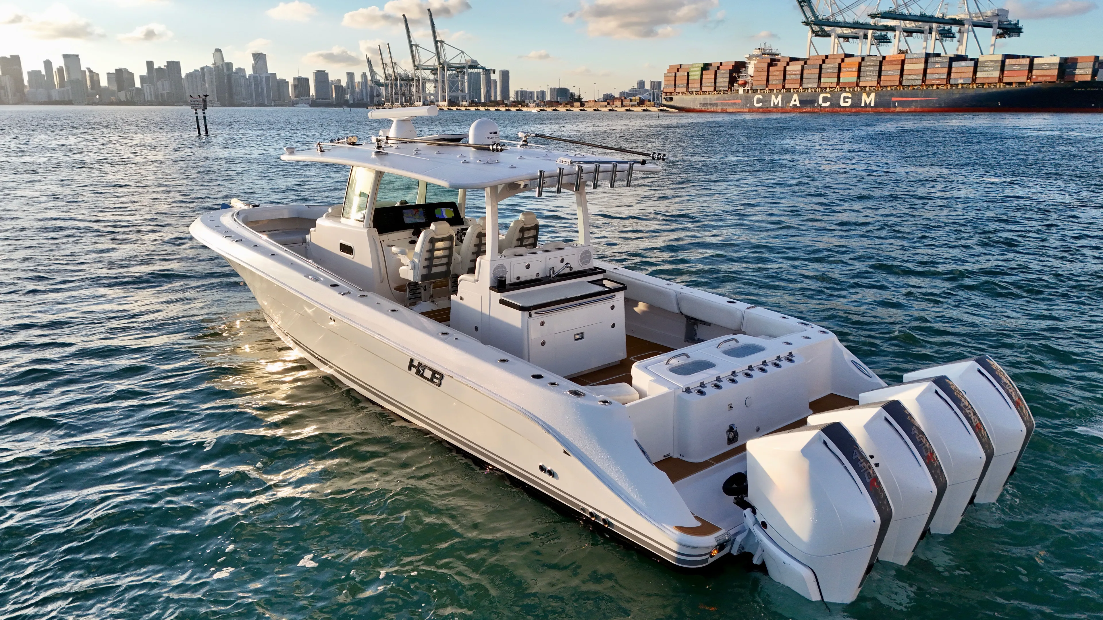  Yacht Photos Pics Luxurious 2021 HCB Lujo boat on water with city skyline background.