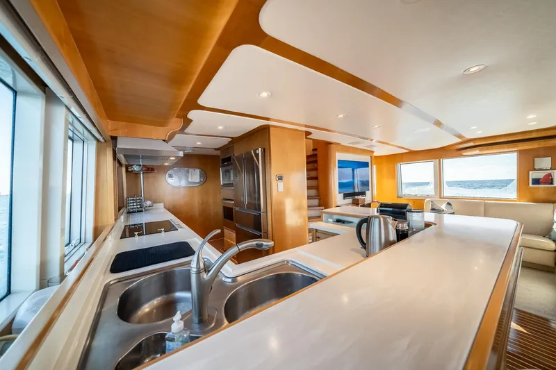 Destination Yacht Photos Pics Luxurious kitchen interior of 2007 MCP Tri-Deck yacht with modern appliances and ocean view.