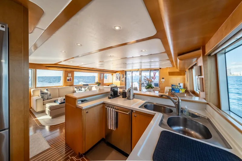 Destination Yacht Photos Pics Luxurious interior of 2007 MCP Tri-Deck yacht with modern kitchen and ocean view.