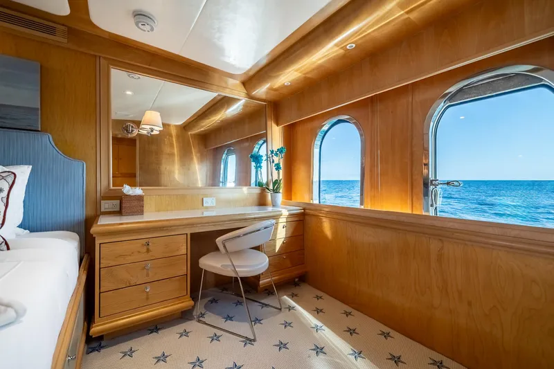 Destination Yacht Photos Pics Luxurious cabin interior of 2007 MCP Tri-Deck yacht with ocean view through portholes.
