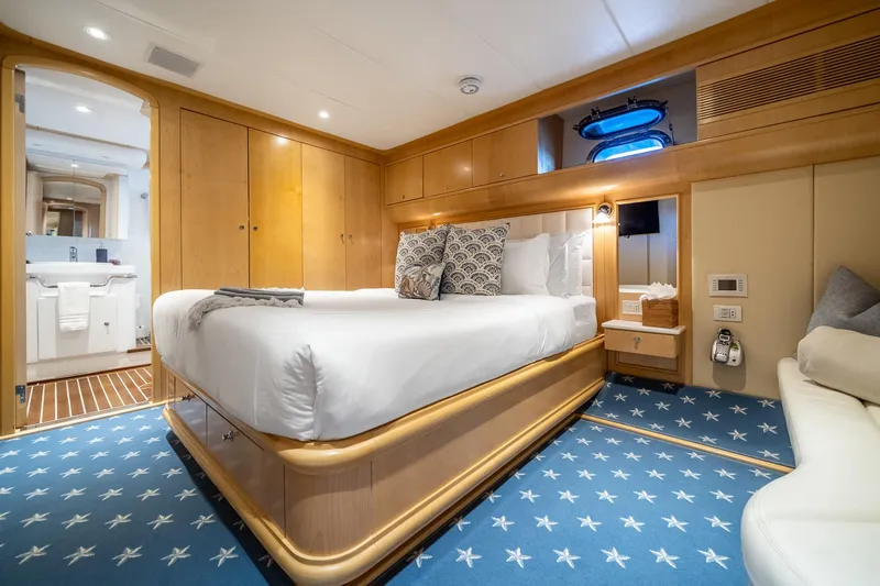 Destination Yacht Photos Pics Luxurious bedroom on 2007 MCP Tri-Deck yacht with elegant decor and plush bedding.