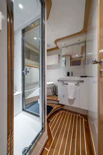 Destination Yacht Photos Pics Luxurious bathroom on 2007 MCP Tri-Deck yacht with modern fixtures and wooden flooring.