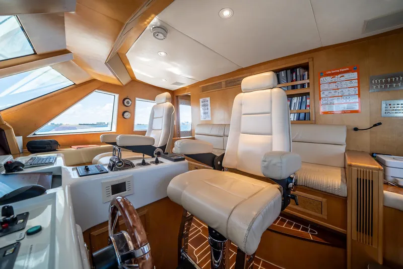 Destination Yacht Photos Pics Luxurious 2007 MCP Tri-Deck yacht interior with plush seating and modern navigation equipment.