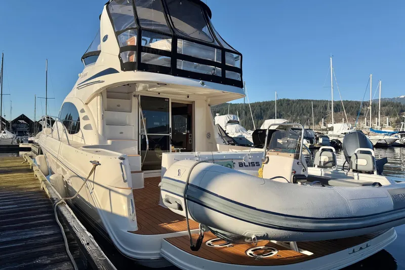 Barefoot Bliss Yacht Photos Pics 2007 Sea Ray 44 Sedan Bridge yacht docked with inflatable boat on deck.