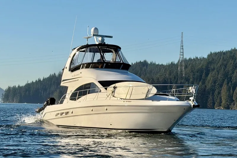 Barefoot Bliss Yacht Photos Pics 2007 Sea Ray 44 Sedan Bridge yacht cruising on a scenic lake.