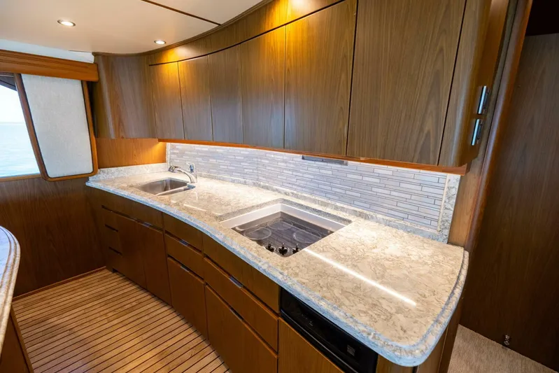 Mighty Mouse Yacht Photos Pics Luxurious kitchen interior of 2011 Viking 70 Convertible yacht with modern wood cabinetry.