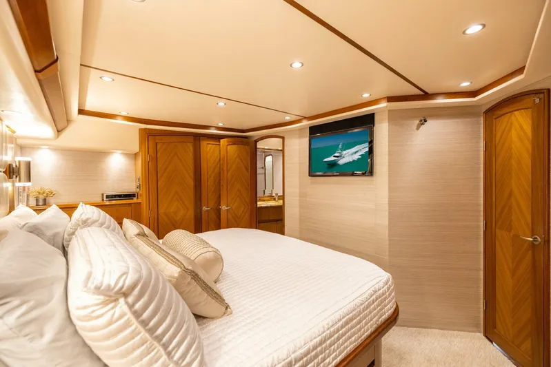 Mighty Mouse Yacht Photos Pics Luxurious bedroom interior of 2011 Viking 70 Convertible yacht with elegant wood finishes.