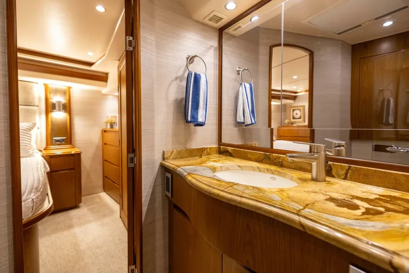 Mighty Mouse Yacht Photos Pics Luxurious bathroom interior of 2011 Viking 70 Convertible yacht with elegant wood and marble finishes.
