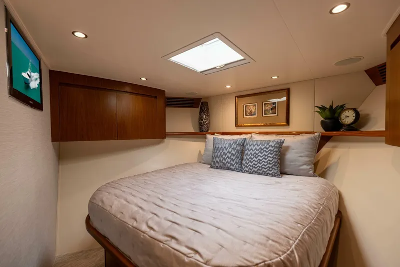Mighty Mouse Yacht Photos Pics Luxurious bedroom interior of 2011 Viking 70 Convertible yacht with cozy bedding and elegant decor.