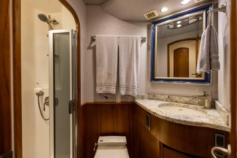 Mighty Mouse Yacht Photos Pics Luxurious bathroom in 2011 Viking 70 Convertible yacht with shower, sink, and towels.