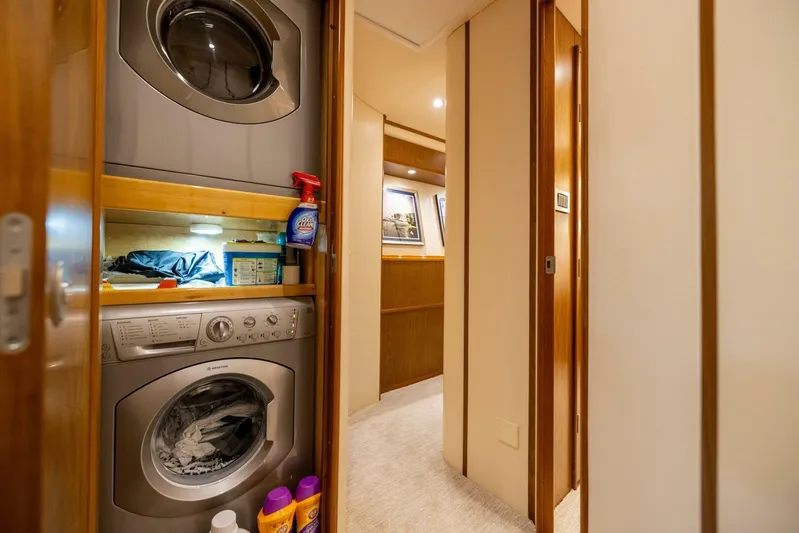 Mighty Mouse Yacht Photos Pics Laundry area inside 2011 Viking 70 Convertible yacht, featuring stacked washer and dryer.
