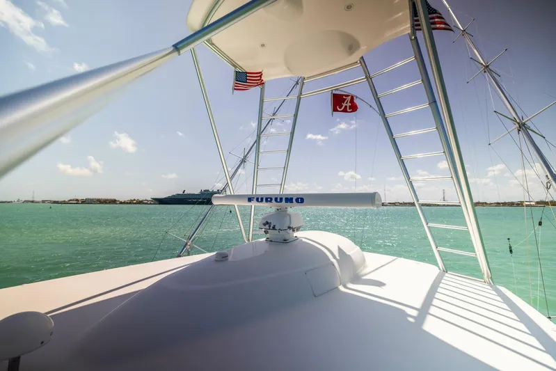 Mighty Mouse Yacht Photos Pics 2011 Viking 70 Convertible yacht with radar, flags, and ocean view.