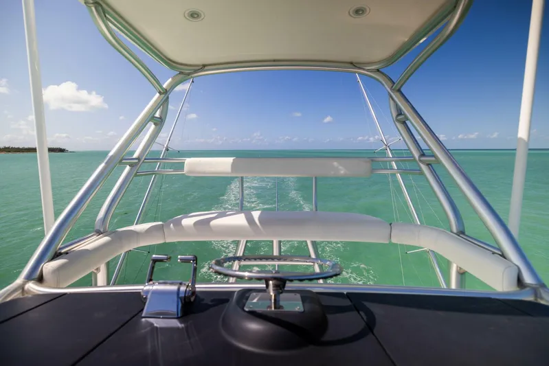 Mighty Mouse Yacht Photos Pics 2011 Viking 70 Convertible yacht navigating turquoise waters under a clear blue sky.