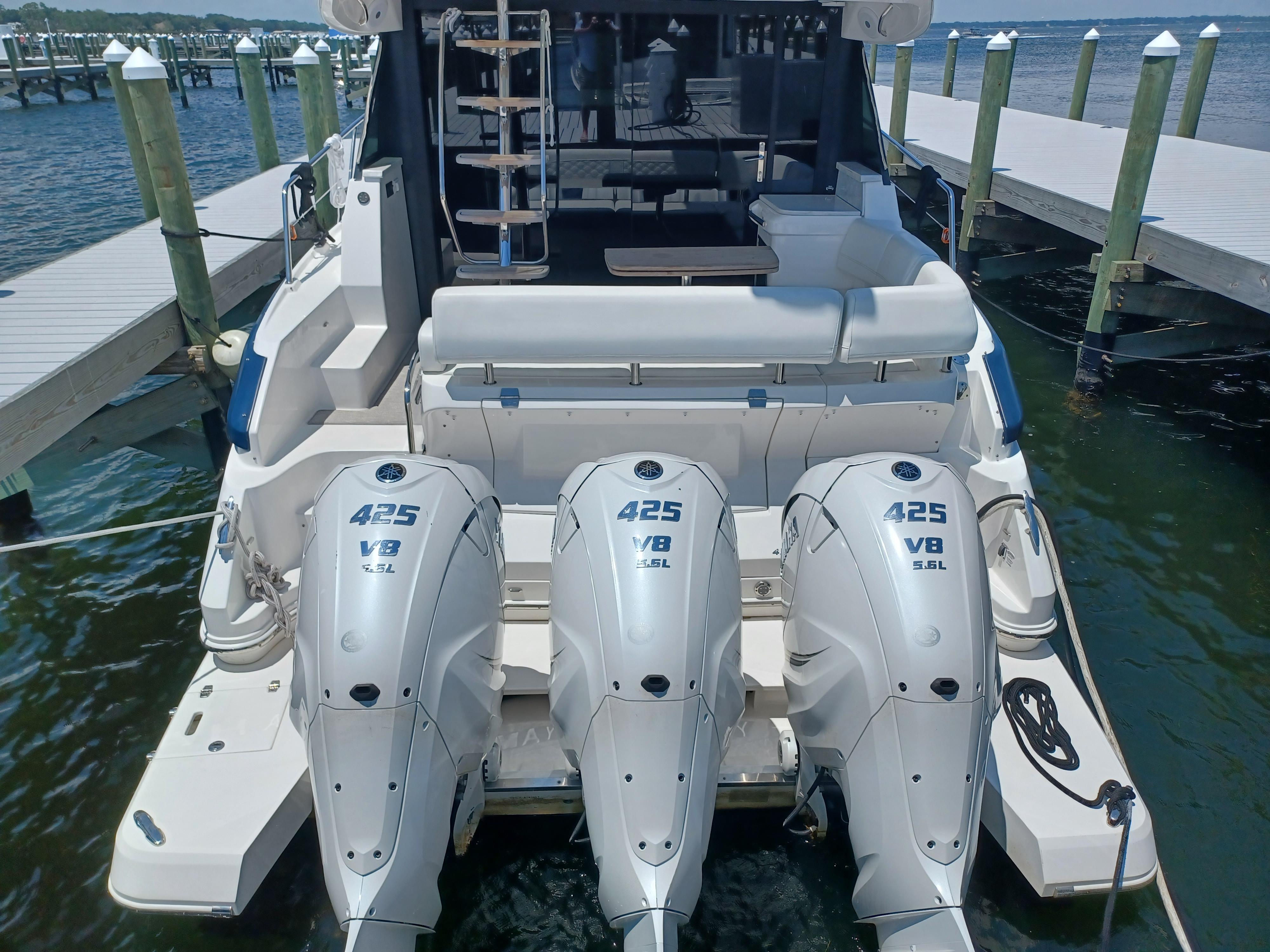2023 Regal 42 FXO boat with triple 425 V8 engines docked at marina.