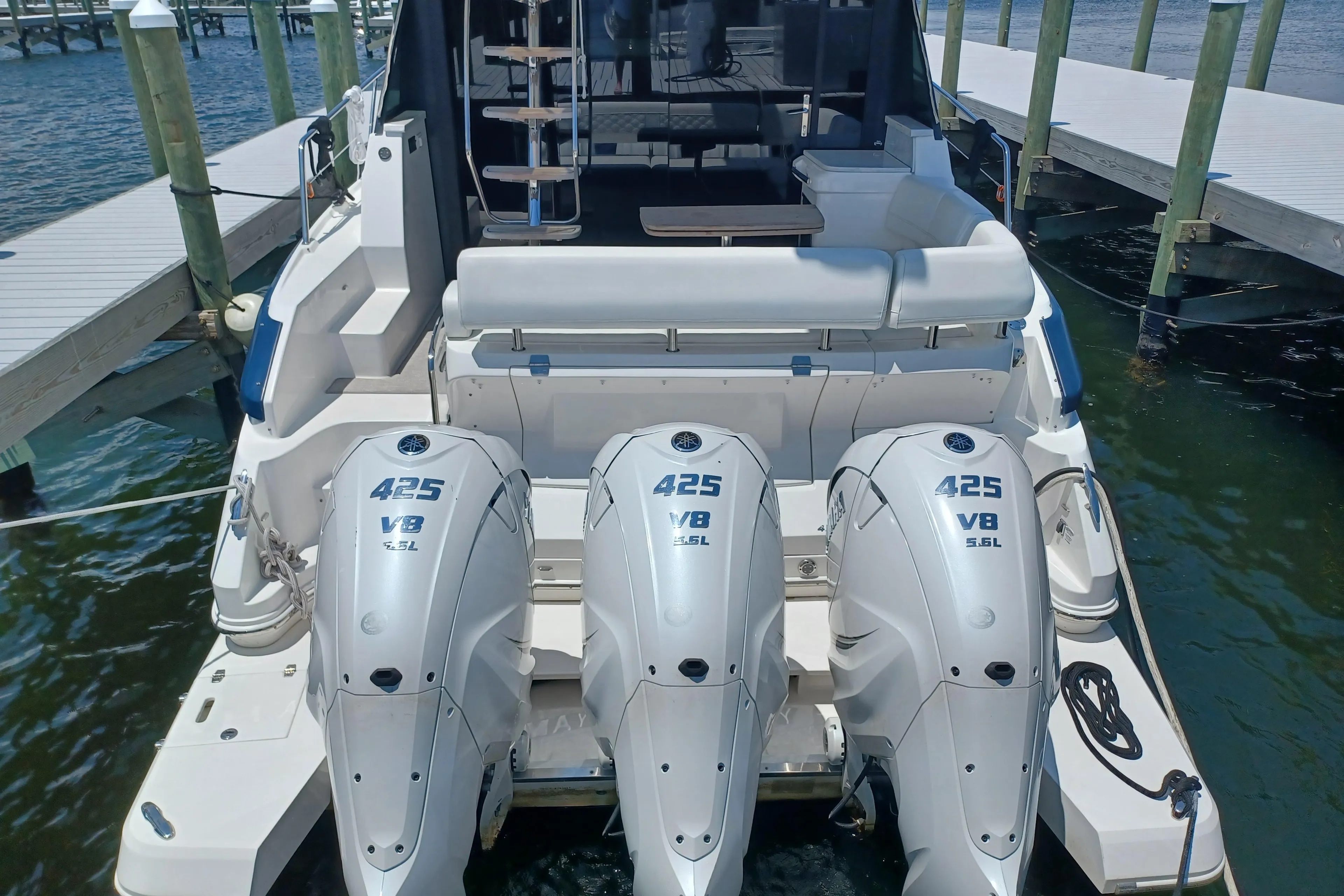 2023 Regal 42 FXO boat with triple 425 V8 engines docked at marina.