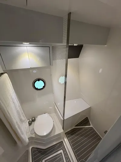  Yacht Photos Pics Modern bathroom in 2024 Evolve 400HT yacht with sleek design and porthole window.