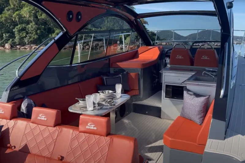  Yacht Photos Pics 2024 Evolve 400HT luxury yacht interior with red seating and dining area.