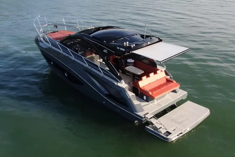  Yacht Photos Pics 2024 Evolve 400HT luxury yacht on calm water, rear view.