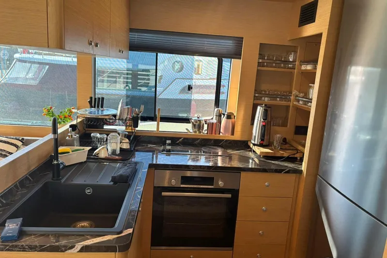  Yacht Photos Pics Modern kitchen interior on 2025 KRC Yachting KRC57 yacht, featuring sleek appliances and marble countertops.