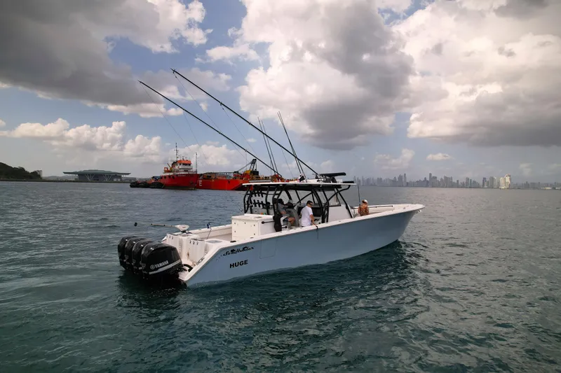  Yacht Photos Pics 2018 SeaHunter 45 Tournament boat on water with city skyline and cloudy sky.