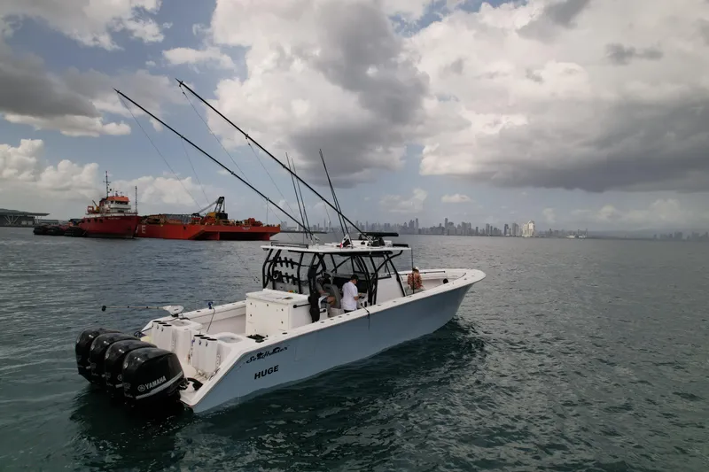  Yacht Photos Pics 2018 SeaHunter 45 Tournament boat on water with city skyline and cloudy sky.