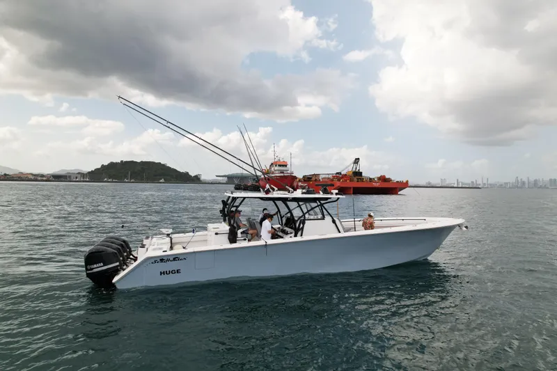  Yacht Photos Pics 2018 SeaHunter 45 Tournament boat on water, with fishing rods, cloudy sky, and distant ships.
