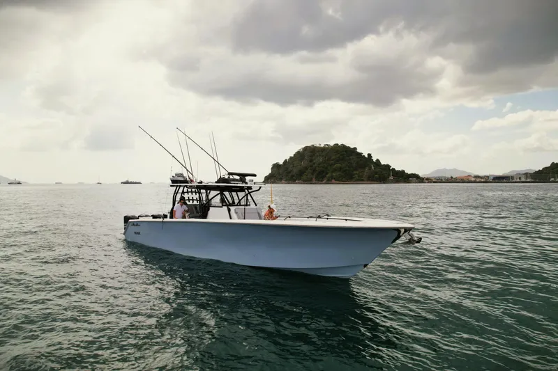  Yacht Photos Pics 2018 SeaHunter 45 Tournament boat on calm waters with fishing rods, cloudy sky backdrop.