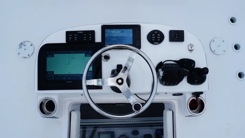  Yacht Photos Pics Control panel of 2018 SeaHunter 45 Tournament boat with steering wheel and navigation screens.