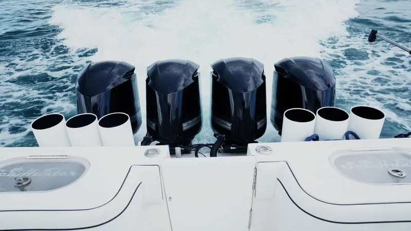  Yacht Photos Pics Four powerful outboard motors on a 2018 SeaHunter 45 Tournament boat cruising through water.