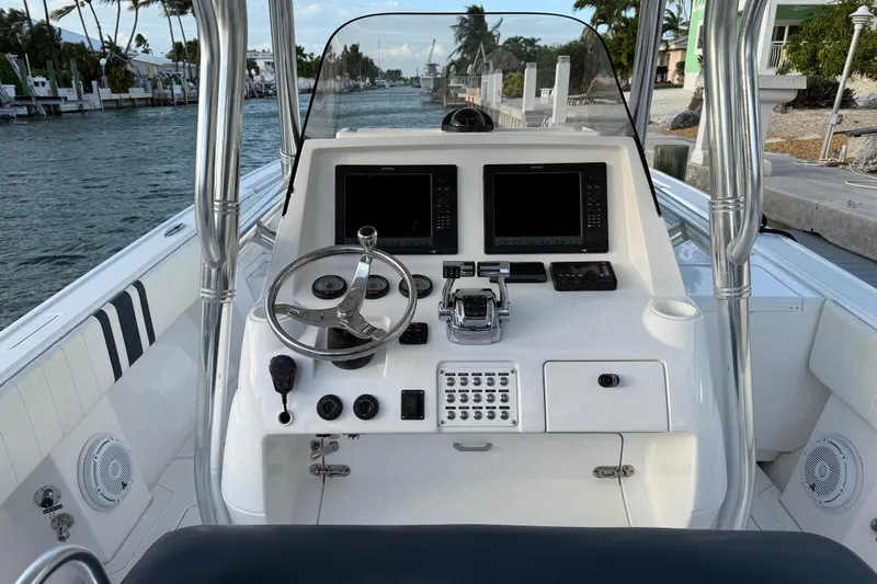  Yacht Photos Pics Cockpit of 2013 Intrepid 327 Cuddy boat with steering wheel and navigation screens.