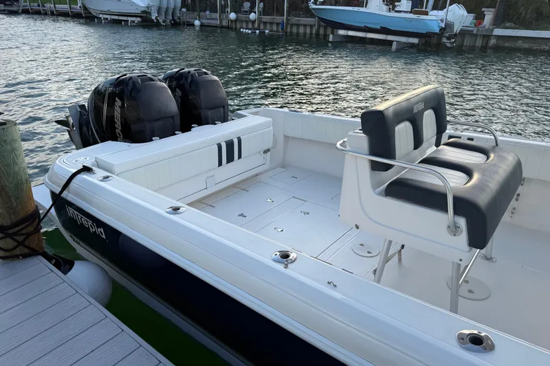  Yacht Photos Pics 2013 Intrepid 327 Cuddy boat docked, featuring dual engines and spacious seating.