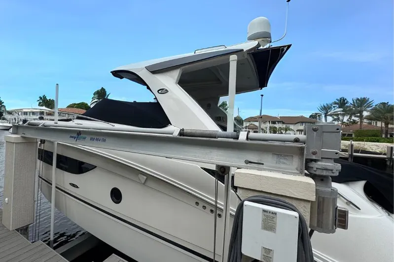  Yacht Photos Pics 2016 Sea Ray 350 Sundancer docked, side view with clear blue sky.