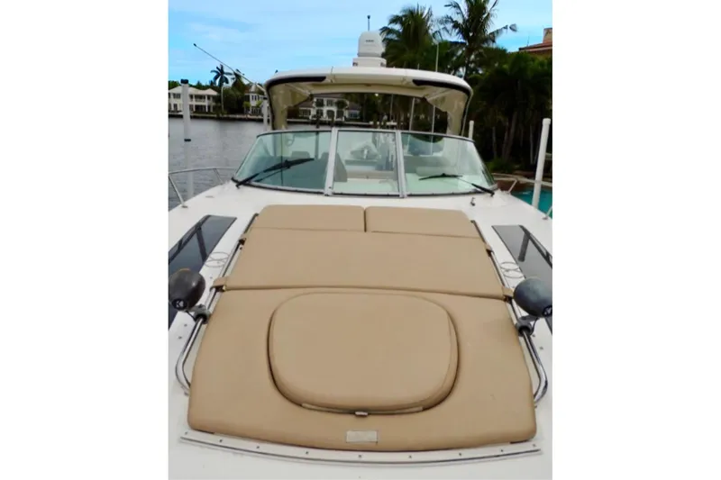  Yacht Photos Pics 2016 Sea Ray 350 Sundancer yacht with spacious sunbathing deck, docked near palm trees.