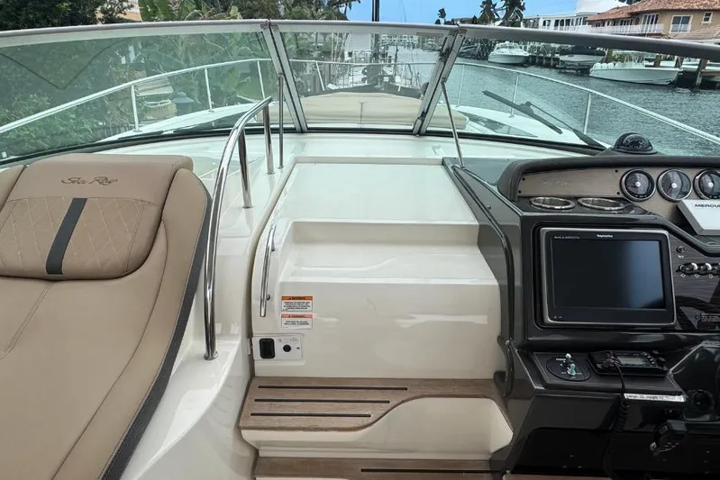  Yacht Photos Pics 2016 Sea Ray 350 Sundancer cockpit with helm, seating, and navigation controls.