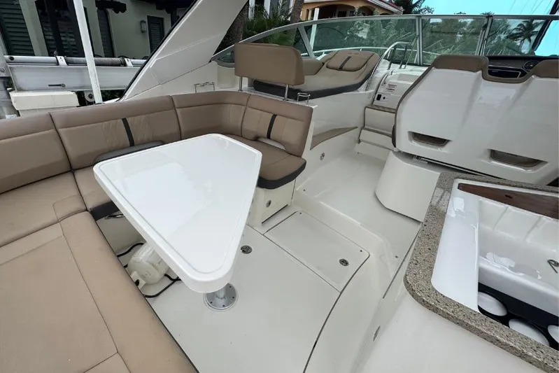  Yacht Photos Pics 2016 Sea Ray 350 Sundancer interior with beige seating and white table.