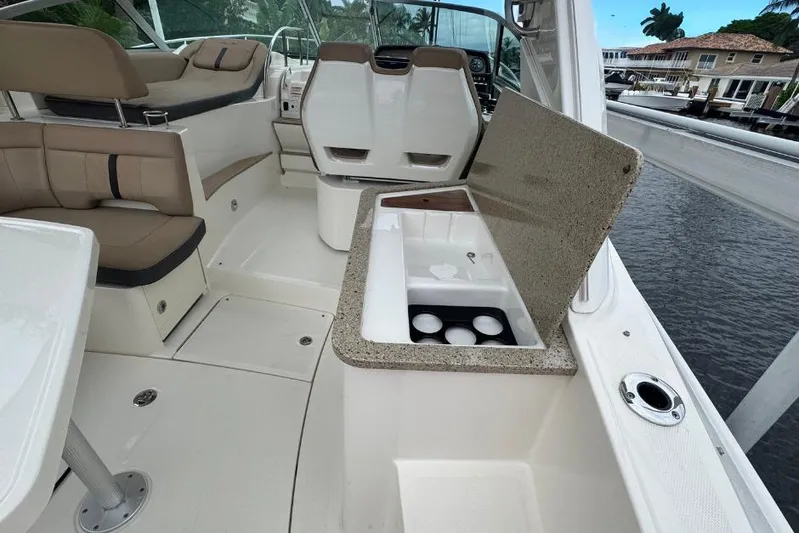  Yacht Photos Pics Interior of 2016 Sea Ray 350 Sundancer with seating and open storage compartment.