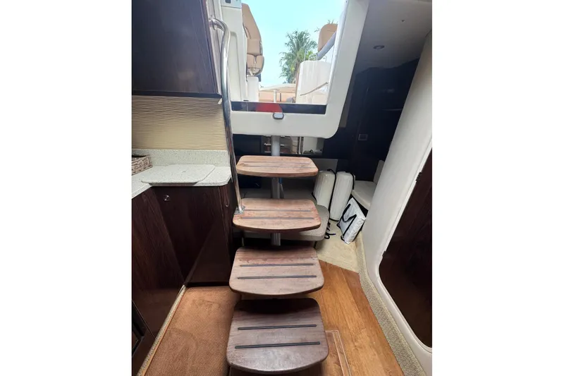  Yacht Photos Pics Interior view of 2016 Sea Ray 350 Sundancer yacht with wooden steps and modern design.
