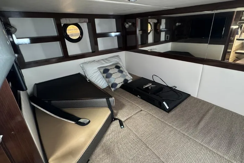  Yacht Photos Pics 2016 Sea Ray 350 Sundancer cabin interior with bed, pillows, and porthole window.