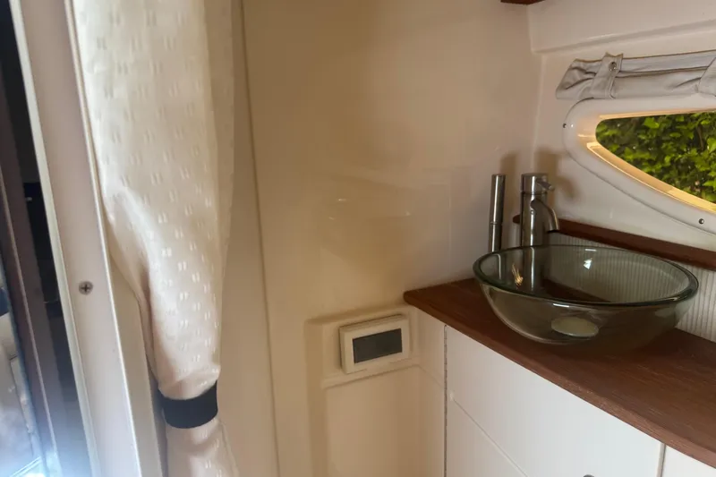  Yacht Photos Pics Luxurious bathroom interior of 2016 Sea Ray 350 Sundancer yacht with glass sink.