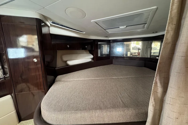  Yacht Photos Pics Interior cabin of 2016 Sea Ray 350 Sundancer with elegant wood finish and spacious bed.