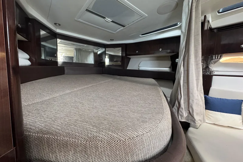  Yacht Photos Pics Luxurious interior cabin of 2016 Sea Ray 350 Sundancer yacht with plush bedding.