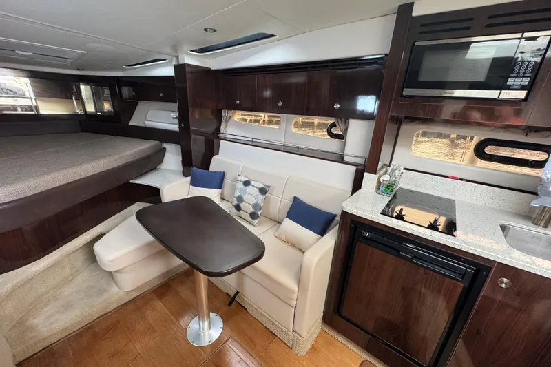  Yacht Photos Pics Luxurious interior of 2016 Sea Ray 350 Sundancer yacht with kitchenette and seating area.