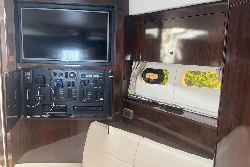  Yacht Photos Pics Interior of 2016 Sea Ray 350 Sundancer with control panel and TV setup.