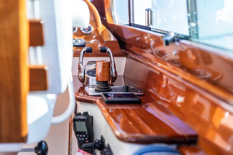Leodes Yacht Photos Pics Interior of 2022 Hinckley Picnic Boat 34 S with polished wood and control panel.