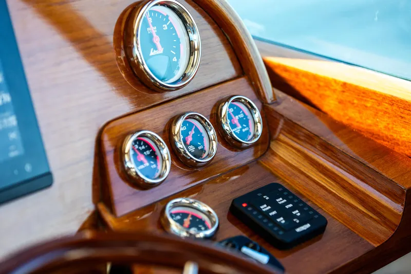 Leodes Yacht Photos Pics Dashboard of 2022 Hinckley Picnic Boat 34 S with wooden finish and gauges.